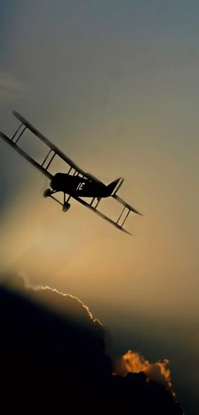 Silhouette of vintage airplane flying against a dramatic sunset sky.