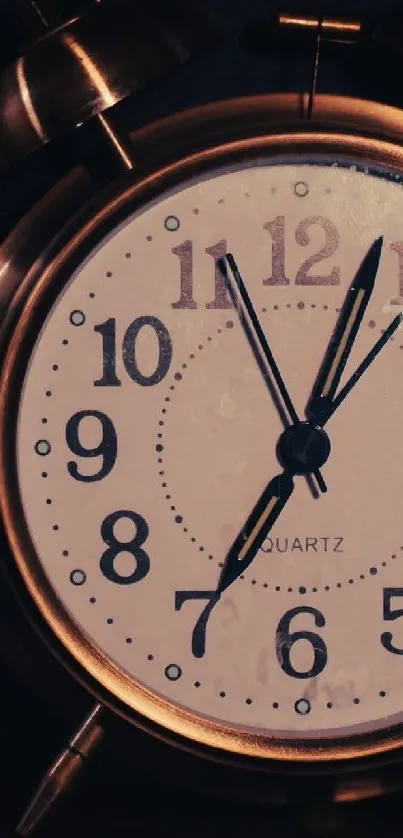 Vintage alarm clock with bronze finish and classic numeral design.