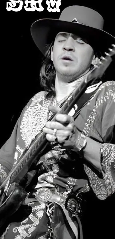 Black and white image of a vintage guitarist in ornate outfit.