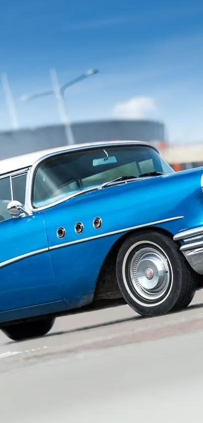 Vintage blue car parked under a clear sky.