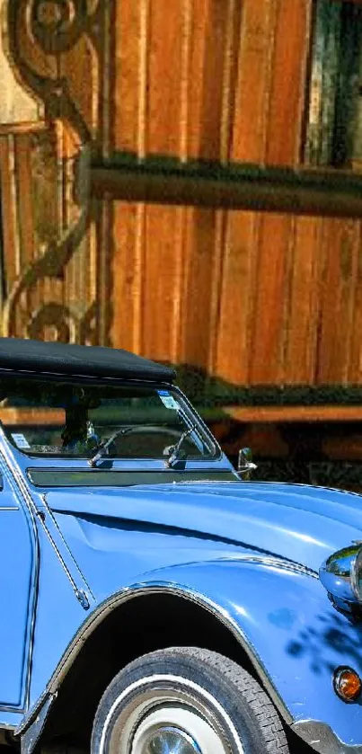 Vintage blue car in front of wooden house.