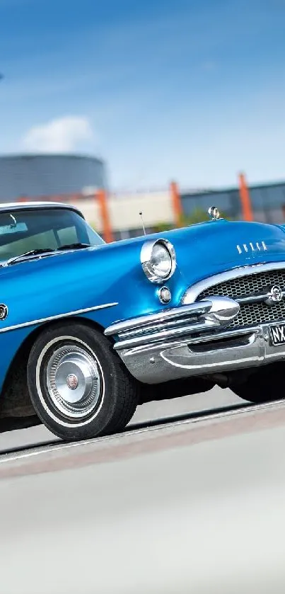 Vintage blue car parked in front of a building under a clear sky.