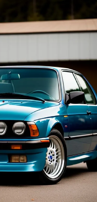 Vintage blue car displayed in elegant wallpaper.