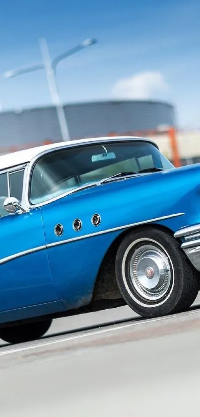 Vintage blue car with a clear sky background.