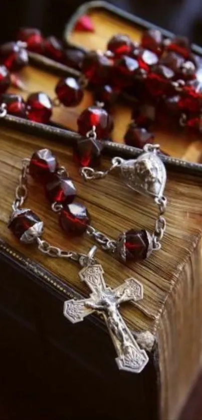 Vintage book with rosary beads and cross on top.