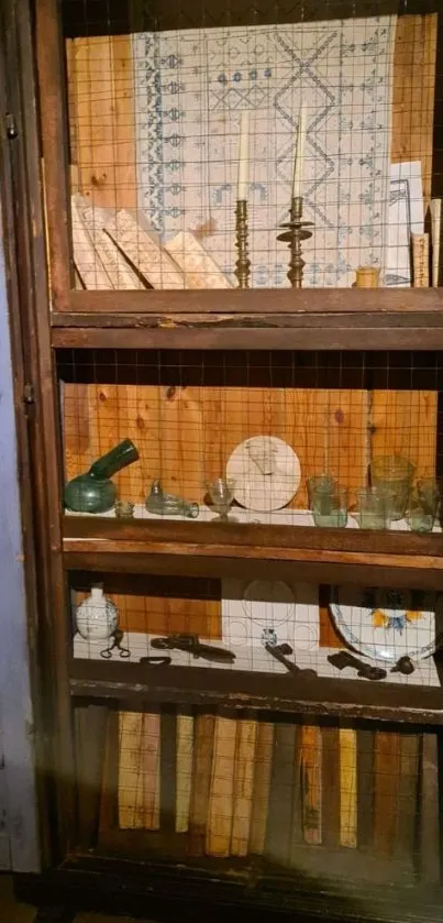 Vintage bookshelf with antiques and books in a wooden cabinet.