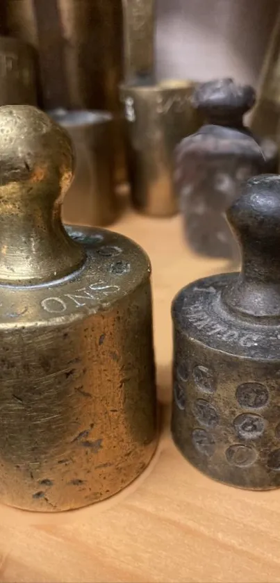 Close-up of vintage brass weights on display.