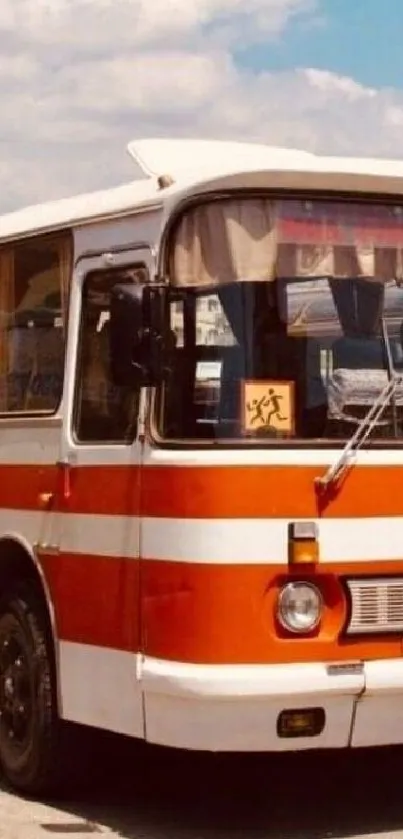 Vintage orange and white bus with retro style parked outdoors.