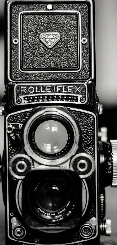 A black and white vintage Rolleiflex camera in close-up.