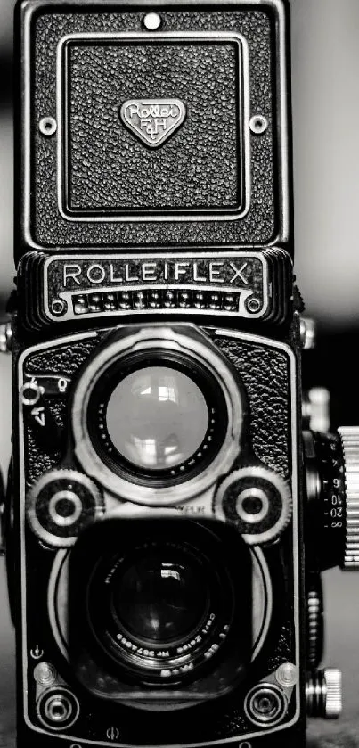 Black and white vintage Rolleiflex camera image.