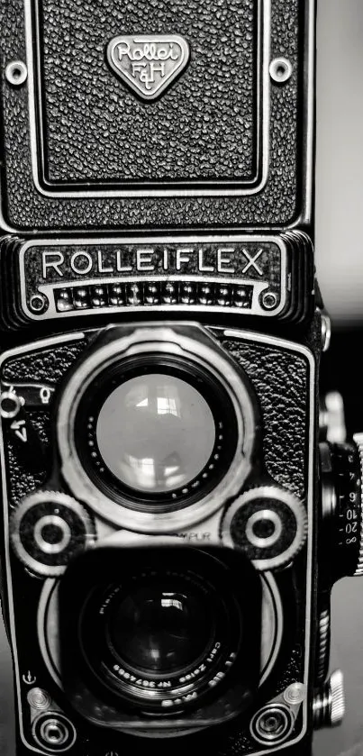 Vintage Rolleiflex camera in monochrome photography style.