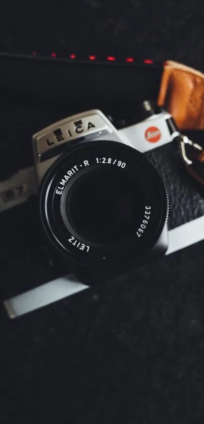 Vintage Leica camera on dark background, stylish mobile wallpaper.