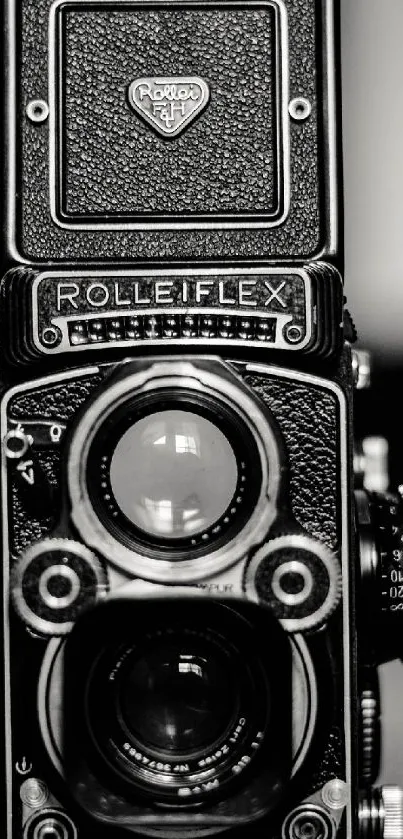 Close-up of a vintage Rolleiflex camera in black and white.