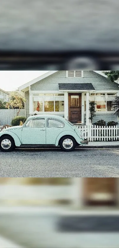 Vintage teal car parked by a cozy house with white picket fence.