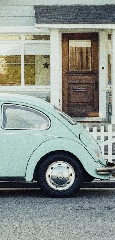 Mint green vintage car in front of a cozy house with wooden door.