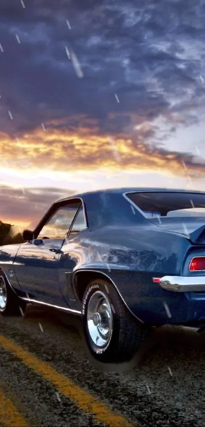 Vintage blue car driving on a road at sunset with a vibrant sky.