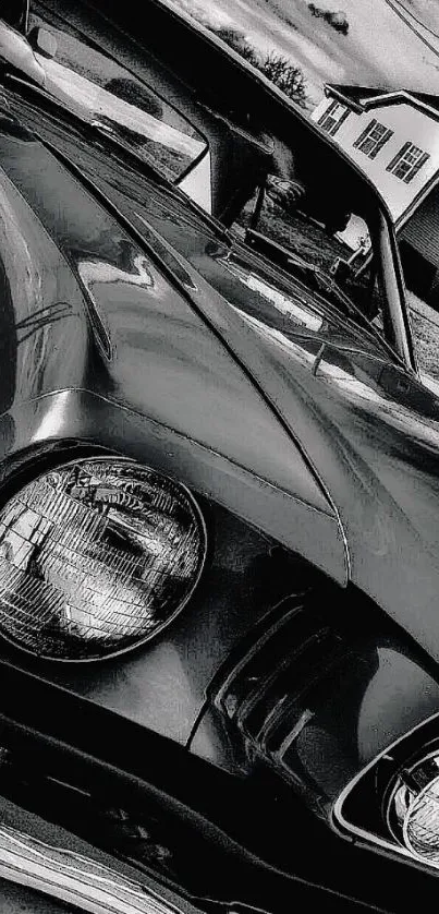 Black and white vintage car close-up with cloudy sky.