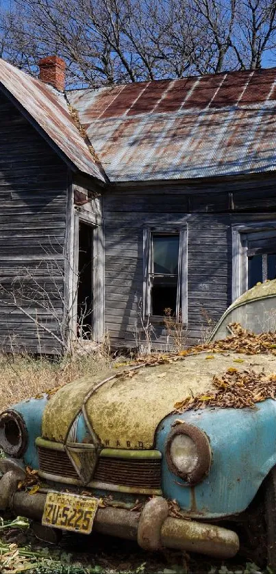 Vintage car in front of an abandoned old house under a clear blue sky.