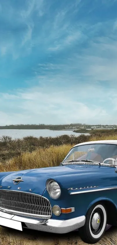 Vintage blue car by a scenic lakeside with a clear sky backdrop.