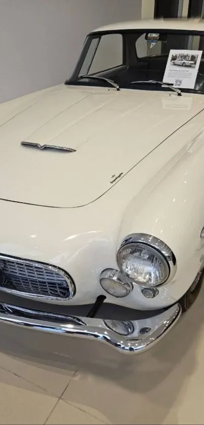 Elegant vintage car with white body showcasing classic style.