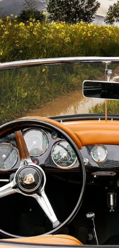 Vintage car dashboard with scenic drive in background.