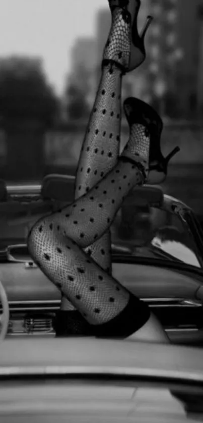 Black and white wallpaper with legs in polka dot stockings in a vintage car scene.