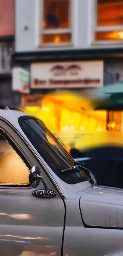 Vintage white car amidst vibrant city lights.