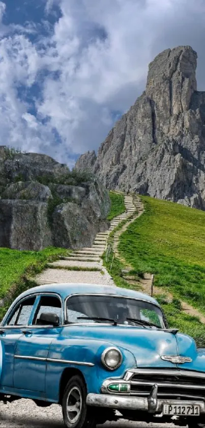 Vintage blue car on mountain road with rocky backdrop.