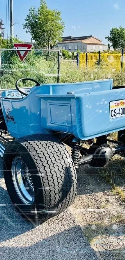 Vintage sky blue car on a rural road.