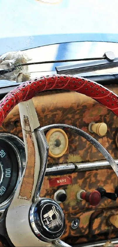 Vintage car interior with red steering and retro design elements.