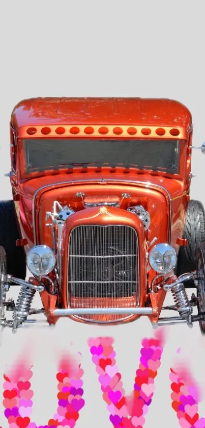 Vintage red car with love-themed heart design on phone wallpaper.