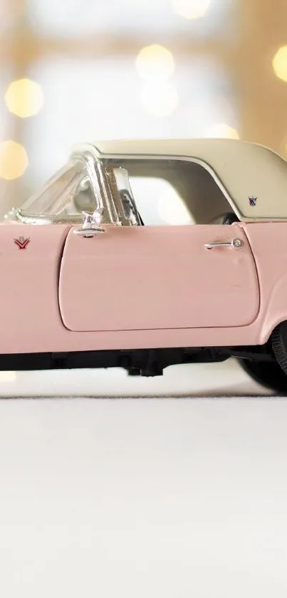 Pink vintage car with soft bokeh lights on mobile wallpaper.