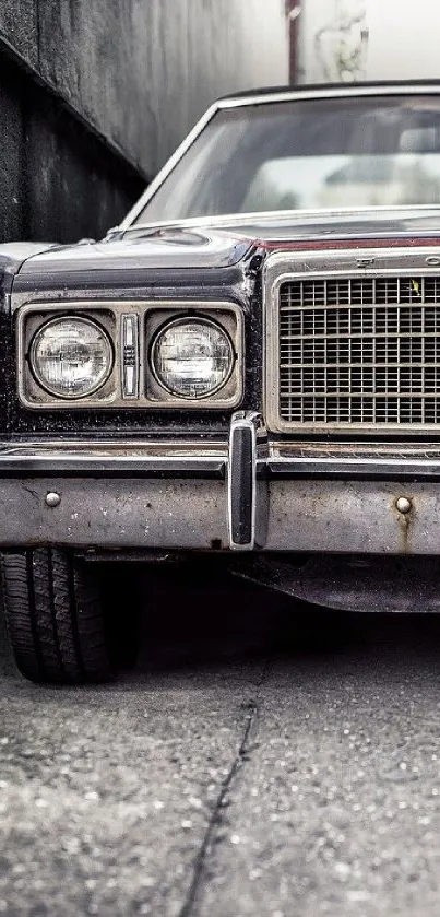 Vintage car parked in an urban setting with a focus on headlights and grill.