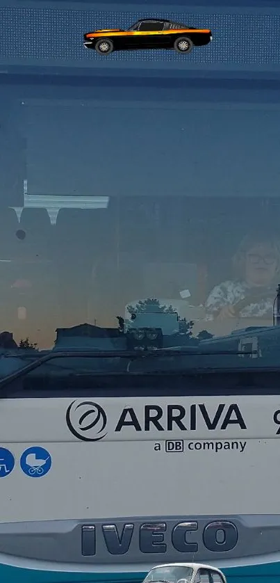 Vintage car on a bus display screen with urban background.