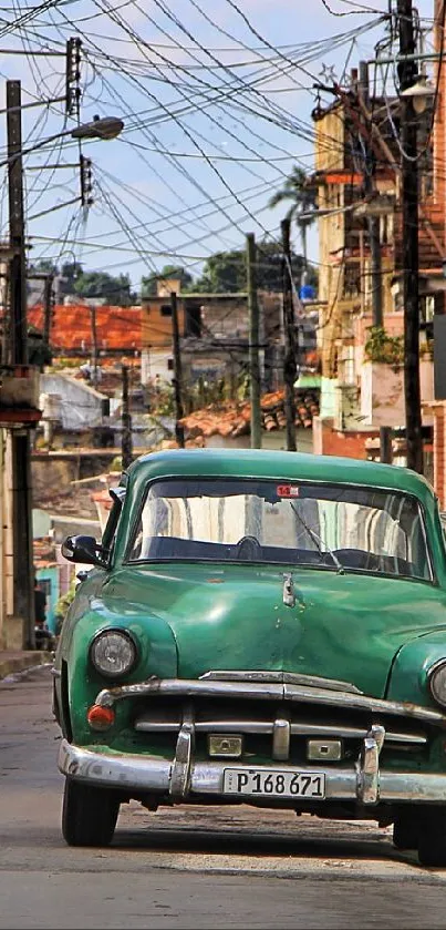 Vintage green car on a rustic street in an urban decay setting.