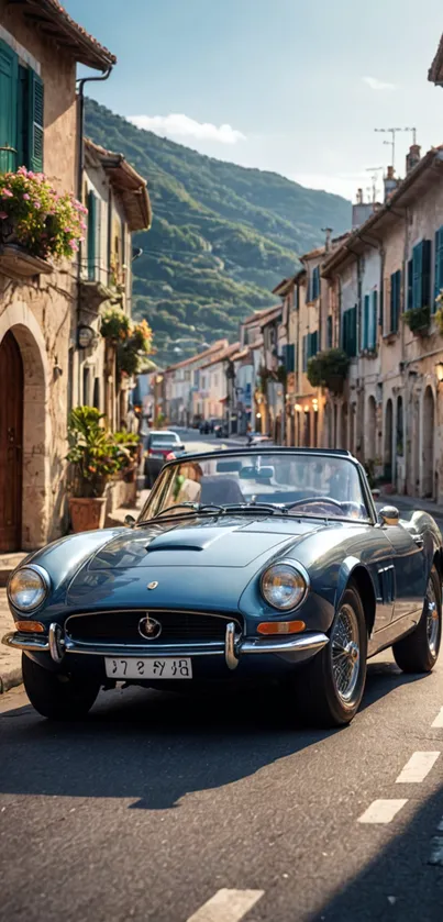 Vintage convertible car on a charming European street with mountain backdrop.