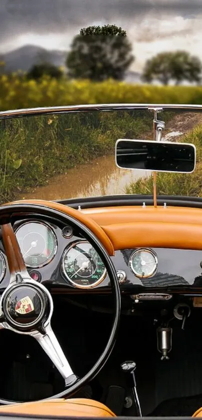 Interior of a vintage car with a scenic road view through the windshield.