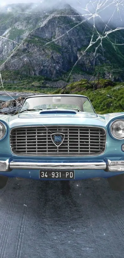 Vintage blue car on scenic mountain road.