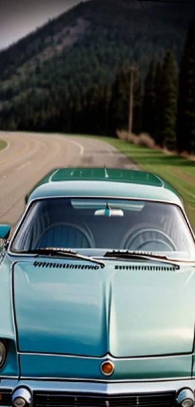 Vintage car on scenic mountain road wallpaper.