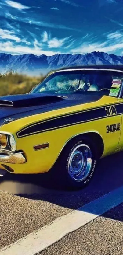 Vintage yellow car on scenic mountain road.