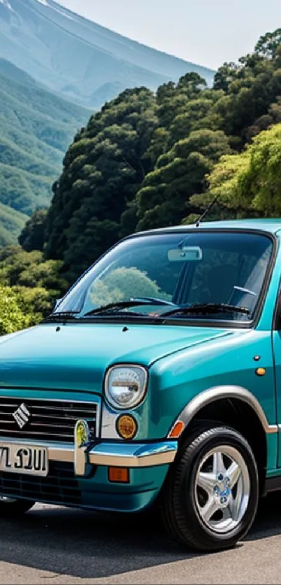 Teal vintage car with mountain landscape background.