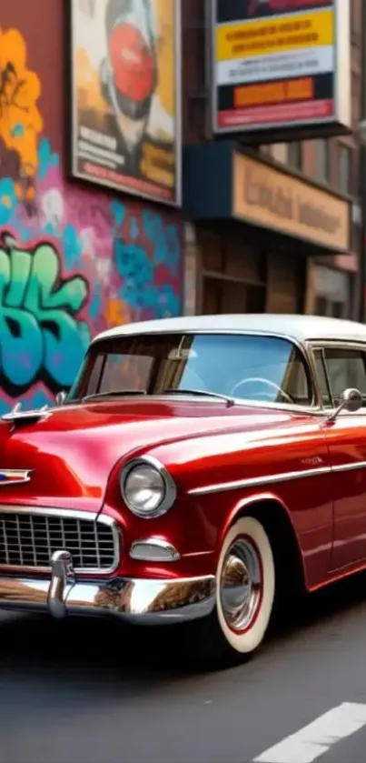 Vintage red car parked against graffiti-covered urban wall.