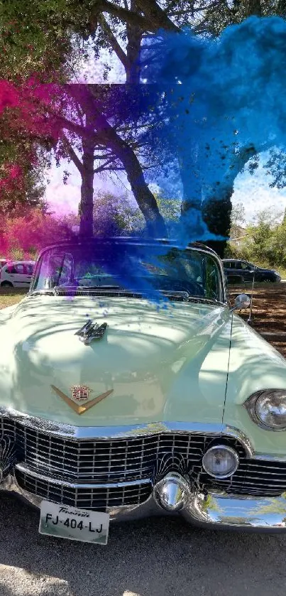 Vintage car with vibrant red, purple, and blue smoke in an outdoor setting.