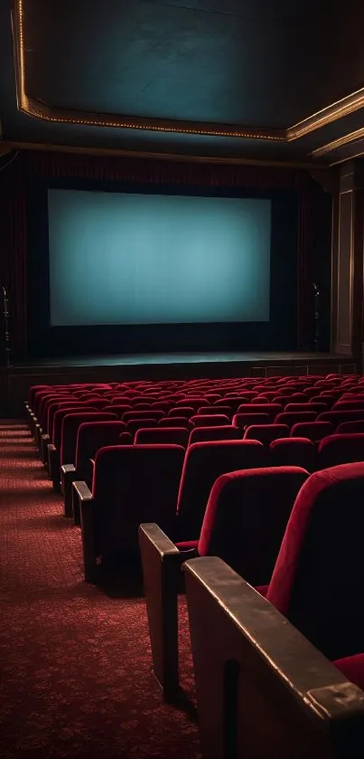 Vintage cinema with red chairs and blank screen.
