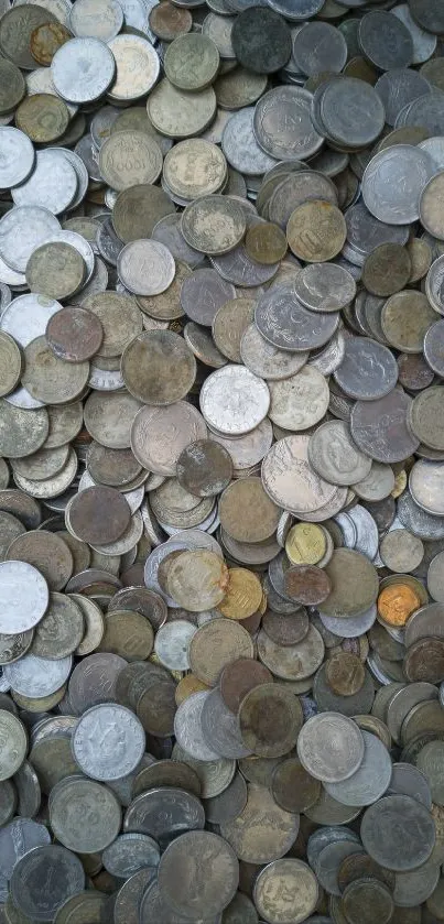 A pile of assorted vintage coins creating a textured, metallic background.