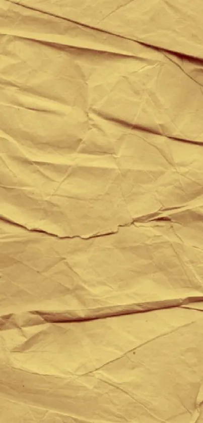 Vintage crumpled paper texture wallpaper with a tan hue.