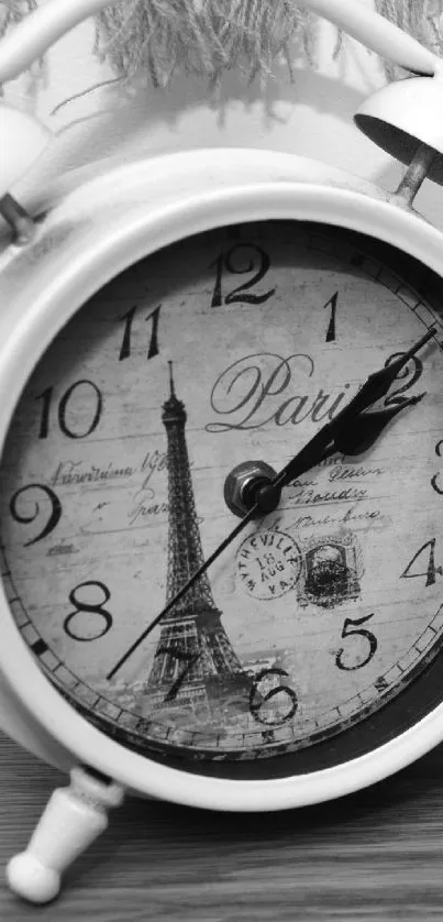 Vintage clock with Eiffel Tower design in grayscale.