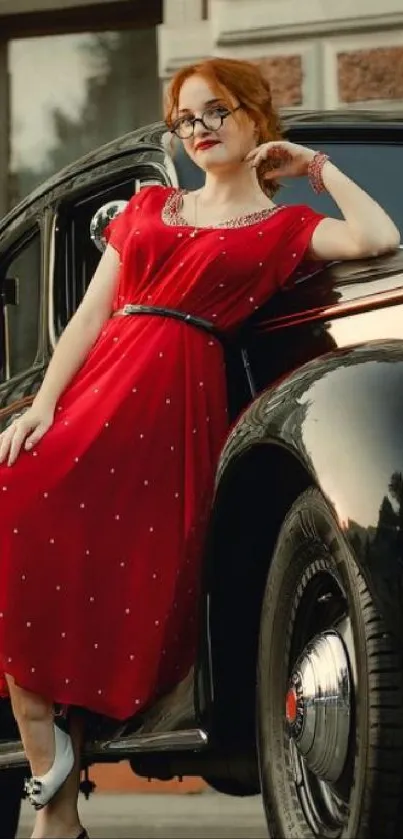 Woman in red dress leaning on a vintage car with a historic building backdrop.