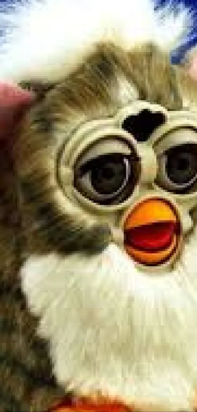 Close-up of vintage Furby toy with white and brown fur, iconic eyes, and orange beak.