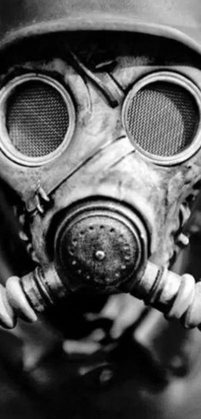 Black and white image of a vintage gas mask with a helmet.